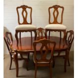 A hardwood dining table with four chairs and two carvers with shell detail (H77cm W172cm D104cm)