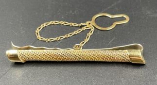 A 14ct three gold brooch with safety chain. (585)