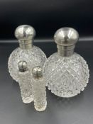 A Pair of silver topped scent bottles hallmarked for London 1892, makers mark GB, with two smaller