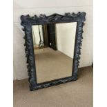 A carved wall mirror (70cm x 98cm)