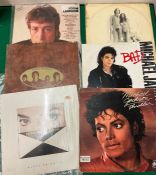 Three Michael Jackson records and three Beatles records