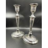 A pair of silver candlesticks by C J Vander Ltd, and hallmarked for Sheffield 1996 (29cm H)