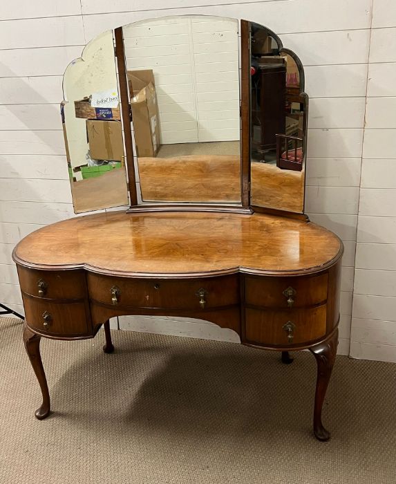 A dressing table with brass drop handles on cabriole legs