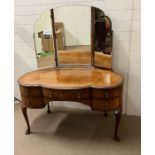 A dressing table with brass drop handles on cabriole legs