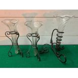 Three twisted glass bud vases in stands