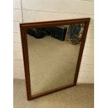 A wall mirror with faux wood frame (70cm x 39cm)