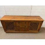 A hardwood sideboard with drawers to centre, flanked by lattice door cupboards (H80cm W179cm D46cm)