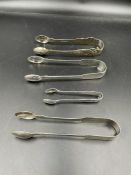 A selection of four silver sugar tongs: 1824 William Chawner, 1827 William Eley, 1867 Charles