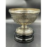 A silver bowl on stand with blank cartouche and flora design, hallmarked for Birmingham 1905
