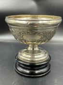 A silver bowl on stand with blank cartouche and flora design, hallmarked for Birmingham 1905