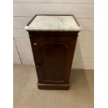 A mahogany pot cupboard with marble top