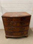 A bow fronted chest of drawers with graduated draws on bracket feet (H84cm W80cm D53cm)