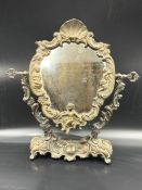 An ornate cast metal mirror