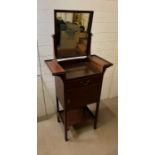 A mahogany wash stand with mirror