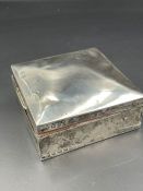 A silver cigarette box, hallmarked for Birmingham 1911