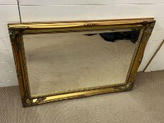 A gilt frame rectangular wall mirror (77cm x 106cm)