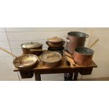 A selection of copper and brass kitchenware, some stamped