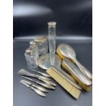 A selection of hallmarked silver vanity items to include glass jars, brushes, mirror etc all