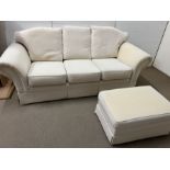 Three seater white sofa and a foot stool