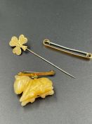 A 9ct gold shamrock brooch (1g) and two 9ct gold brooch fastners.