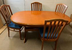 A Stag dining table with slat back chairs (H74cm W170cm D100cm)