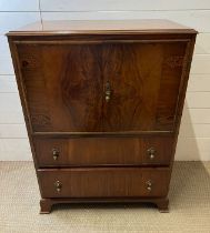A Waring and Gillow cabinet with brass drop handles (H106cm W76cm D46cm)