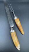 A Pair of Victorian horn handled carving knife and fork, hallmarked for London 1877 by Thomas