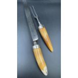 A Pair of Victorian horn handled carving knife and fork, hallmarked for London 1877 by Thomas