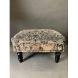 A fabric footstool with drawer.