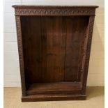 An oak open bookcase with carved details to edge (H123cm W90cm D26cm)