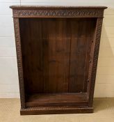 An oak open bookcase with carved details to edge (H123cm W90cm D26cm)