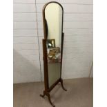 A mahogany cheval mirror on sabre legs