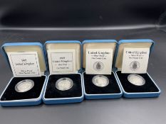 Four silver proof one pound coins to include 1989 and 1990.