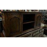A low oak side cabinet with cupboards to each end (H64cm W140cm D47cm)