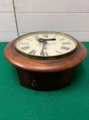 A mahogany wall clock