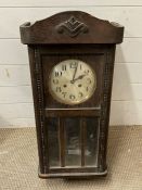 An oak cased wall clock