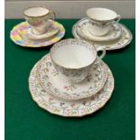 A selection of trio of cups and saucers, various markers