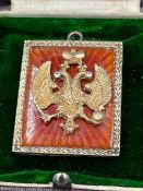 A pendant in the style of Faberge by Henrik Wigstrom, silver 88 orange translucent enamel pendant