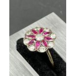 A Daisy style ring with rubies and diamonds (Untested metal band, size L) (Dia of flower 12mm) (