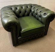 A green leather button back easy armchair Chesterfield