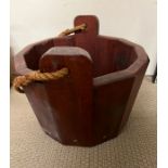 A wooden bucket with rope handle