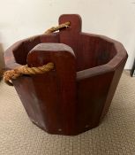 A wooden bucket with rope handle