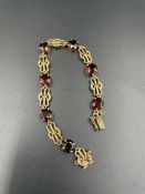 A 9ct gold and garnet bracelet (Total Weight 11.3g)