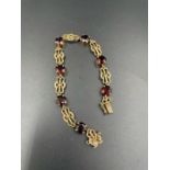 A 9ct gold and garnet bracelet (Total Weight 11.3g)