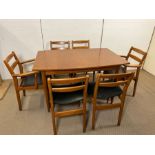 A Mid Century table on tapering legs with six chairs