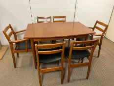 A Mid Century table on tapering legs with six chairs