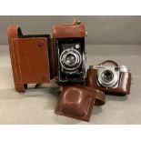 A Volgtlander 35mm camera and a Ensign Selfix 420 both in leather cases