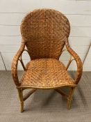 A wicker open arm chair