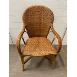 A wicker open arm chair