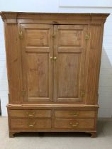 A double antique pine wardrobe with drawers to base (H196cm W153cm D54cm)
